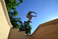 A young guy performs a jump through the space between the concrete parapets Royalty Free Stock Photo
