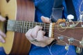 A young guy performs solo on a six-string guitar