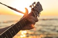 Young guy playing a guitar at sunset Royalty Free Stock Photo