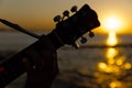 Young guy playing a guitar at sunset Royalty Free Stock Photo