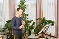 A young guy plays the clarinet from notes. Learning music at home Royalty Free Stock Photo