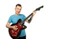 Young guy plays on a retro guitar isolated on a white background Royalty Free Stock Photo