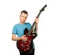 Young guy plays on a retro guitar isolated on a white background Royalty Free Stock Photo