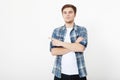 Young guy pointing copy space isolated on white background. Handsome young smiling man in shirt looking at camera pointing away Royalty Free Stock Photo