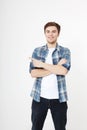 Young guy pointing copy space isolated on white background. Handsome young smiling man in shirt looking at camera and pointing Royalty Free Stock Photo