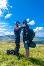 Young guy is preparing for a paragliding flight with an instructor. Extreme hobby and adventure