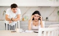 Young guy quarrels with young woman working at laptop Royalty Free Stock Photo