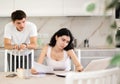 Young guy quarrels with young woman working at laptop Royalty Free Stock Photo