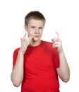 The young guy in a red t-shirt to put cosmetic cream on a face.Portrait on a white background Royalty Free Stock Photo