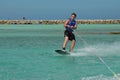 Young Guy Riding Goofy On a Wakeboard in Aruba Royalty Free Stock Photo