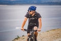 Young guy riding a mountain bike on a bicycle route in Spain. Athlete on a mountain bike rides off-road against the background of Royalty Free Stock Photo
