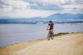 Young guy riding a mountain bike on a bicycle route in Spain. Athlete on a mountain bike rides off-road against the background of Royalty Free Stock Photo