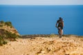 A young guy riding a mountain bike on a bicycle route in Spain on road against the background of the Mediterranean Sea. Dressed in Royalty Free Stock Photo