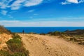 A young guy riding a mountain bike on a bicycle route in Spain on road against the background of the Mediterranean Sea Royalty Free Stock Photo