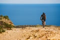 A young guy riding a mountain bike on a bicycle route in Spain on road against the background of the Mediterranean Sea Royalty Free Stock Photo