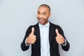 Young guy showing thumbs up sign over gray background Royalty Free Stock Photo