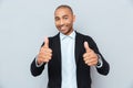 Young guy showing thumbs up sign over gray background Royalty Free Stock Photo