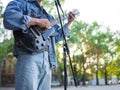 Young guy sings songs and plays guitar on a jeans jacket in a park on a natural background. Royalty Free Stock Photo