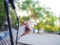 Young guy sings songs and plays guitar on a jeans jacket in a park on a natural background.