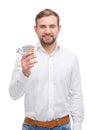 A guy with a smile in jeans holds a plate with pills on a white isolated background