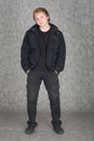Young guy standing on a grey background Royalty Free Stock Photo