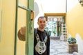 Young guy stands in the open doorway Royalty Free Stock Photo