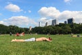 A young guy sunbathing on the grass at the Central Park. Travel around America. Royalty Free Stock Photo