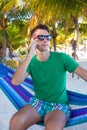 The young guy talking on the phone and relaxing in Royalty Free Stock Photo