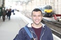 Young guy in train station Royalty Free Stock Photo