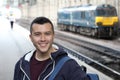 Young guy in train station Royalty Free Stock Photo