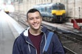 Young guy in train station Royalty Free Stock Photo