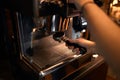 Young guy using coffeemachine , close up cropped photo