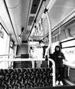 Young guy using mobile phone standing in an empty tram in Berlin Royalty Free Stock Photo