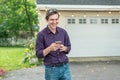 Young guy using smartphone, laughing at text message Royalty Free Stock Photo