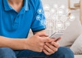 Young guy using smartphone with virtual icons Royalty Free Stock Photo