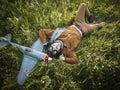 Young guy in vintage clothes pilot with an airplane model outdoors Royalty Free Stock Photo