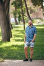 Young guy walking in the spring park. Sunny day. Vesna.Funny guy. A good mood.