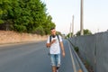 A young guy walks down the street looking at the phone Royalty Free Stock Photo