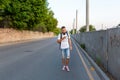 A young guy walks down the street looking at the phone Royalty Free Stock Photo