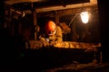 Young guy in a working uniform and protective helmets, sitting in a low tunnel