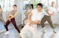 Young guys and girls performing hip hop at group dance class Royalty Free Stock Photo