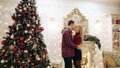 Young guys hugging near the Christmas tree