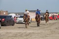 Young guys ride horses along the shore of Lake Shalkar in the West Kazakhstan region