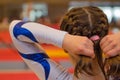 Young gymnast girl fixing hair before appearance Royalty Free Stock Photo