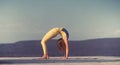 Young gymnast girl perform various gymnastic and yoga exercises, including splits and bending over backwards in front of Royalty Free Stock Photo