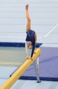 Young gymnast girl performing routine on balance beam Royalty Free Stock Photo