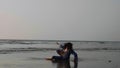 Young gymnast woman doing handspring on sandy beach