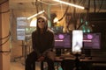 Young hacker with anonymous mask attacking computer server Royalty Free Stock Photo