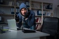 The young hacker hacking into computer at night Royalty Free Stock Photo