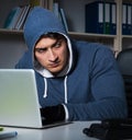 Young hacker hacking into computer at night Royalty Free Stock Photo